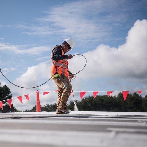 Roof coatings being used on a flat roof