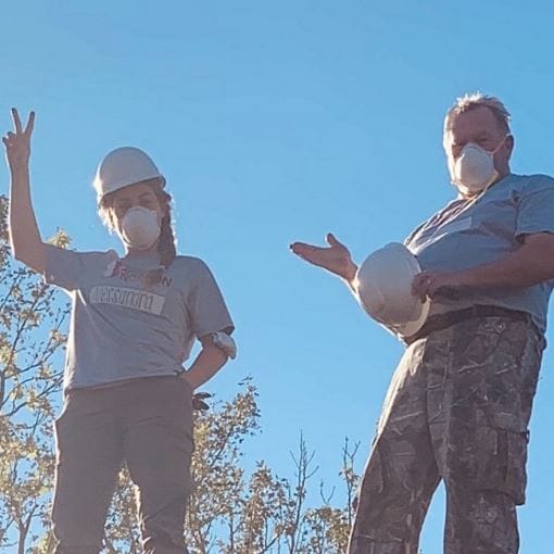 Man and woman in Team Rubicon grey shirts