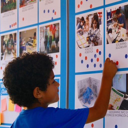 Child placing sticker on bulletin board at the Shafter Learning Center