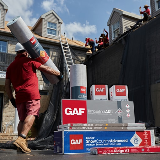 GAF roofing products and contractor in front of a house