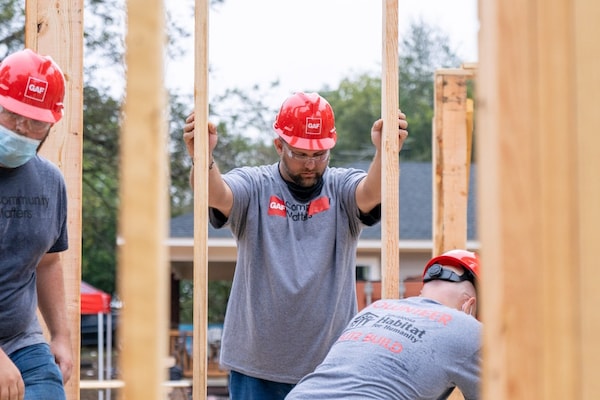 GAF employees and certified roofing contractors helping build a home