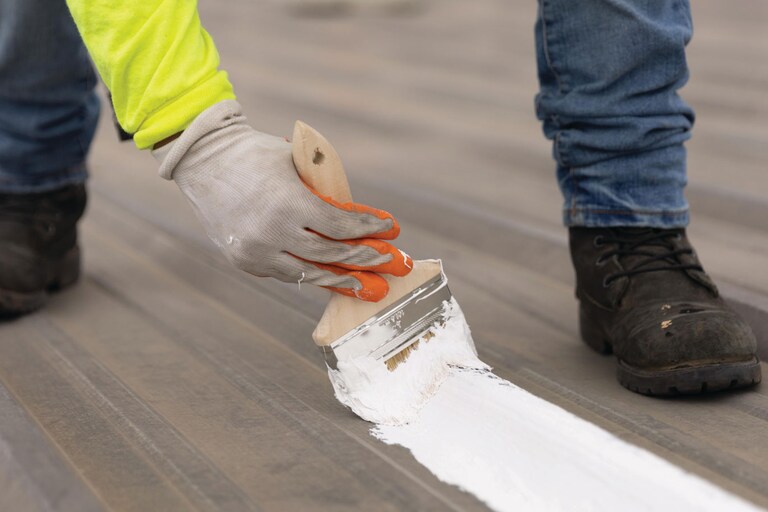 Roofing contractor treating seams