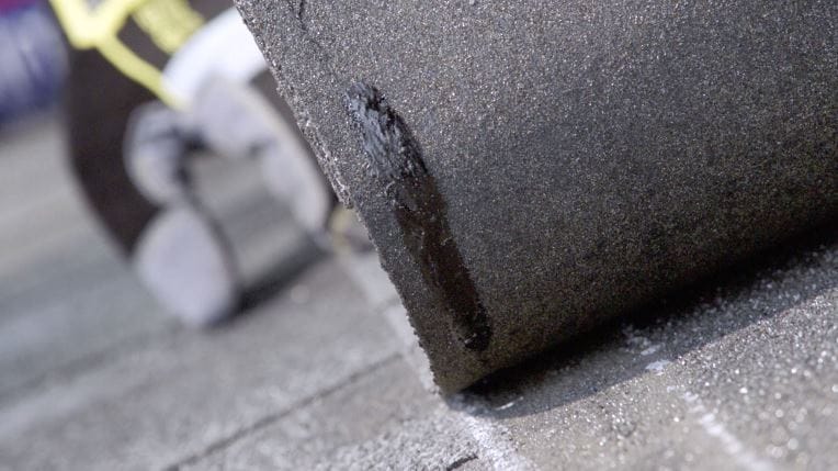 Close-up of GAF roofing shingle back with Dura Grip adhesive