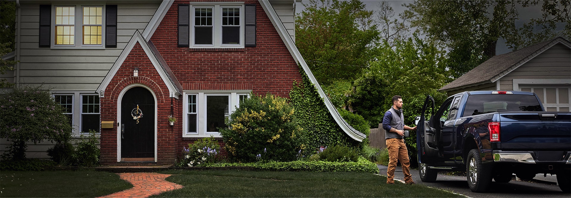 GAF certified roofing contractor near truck outside home