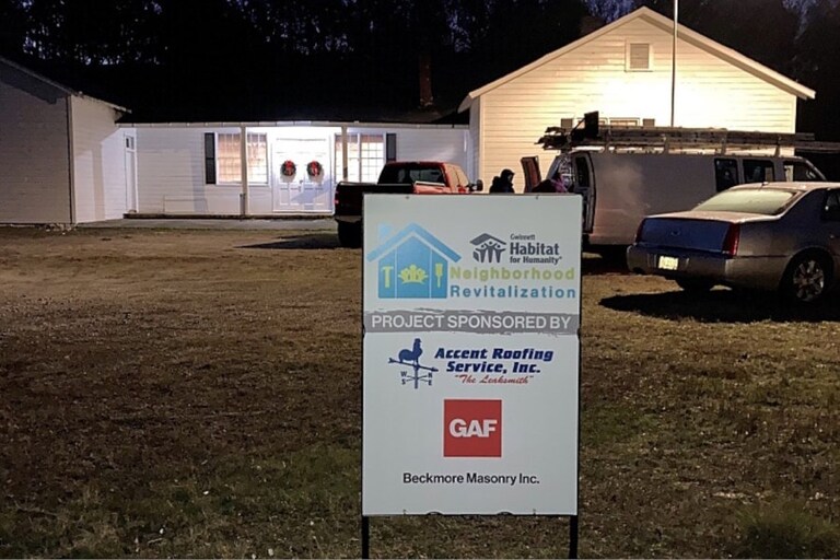 Home with Habitat for Humanity sign in front lawn, sponsored by GAF