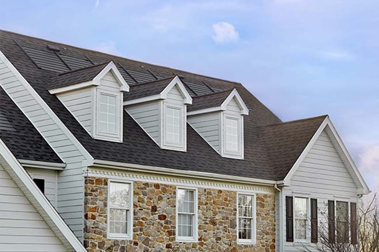 Gray roof with Timberline Solar roofing shingles by GAF Energy