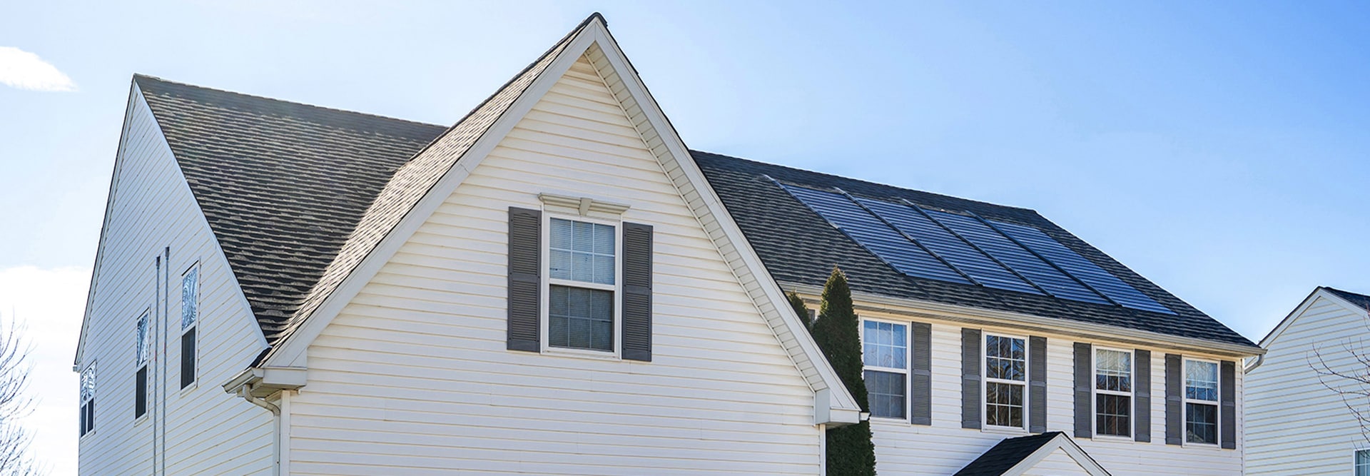 White home with GAF Energy solar roof shingles