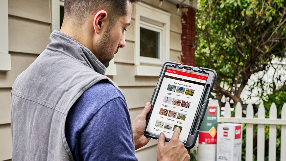 Roofing contractor reviewing GAF rewards on tablet